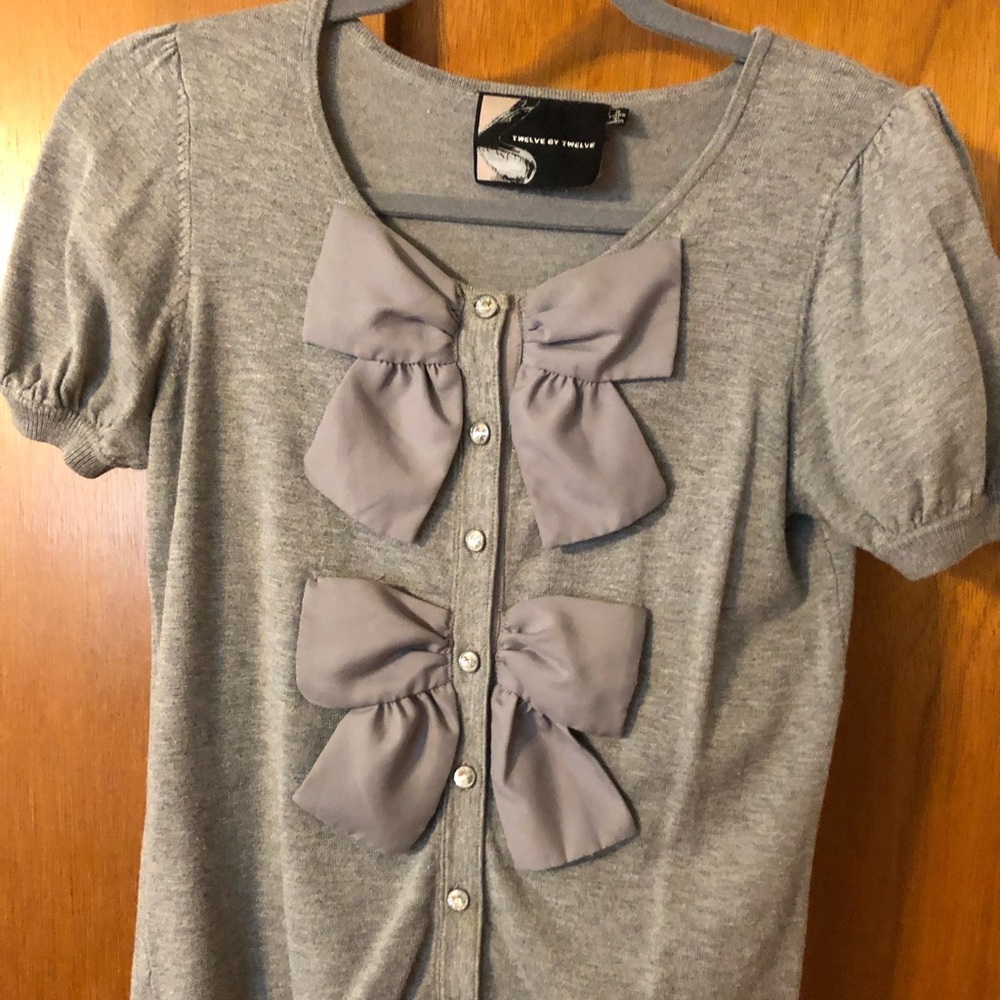 Cute sweater knit top with bow detail.